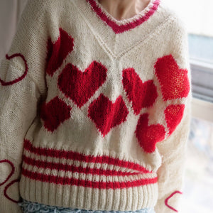 Hand-knitted sweater with lots hearts