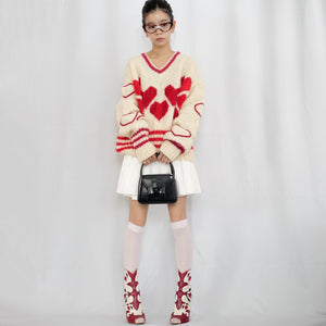 Hand-knitted sweater with lots hearts