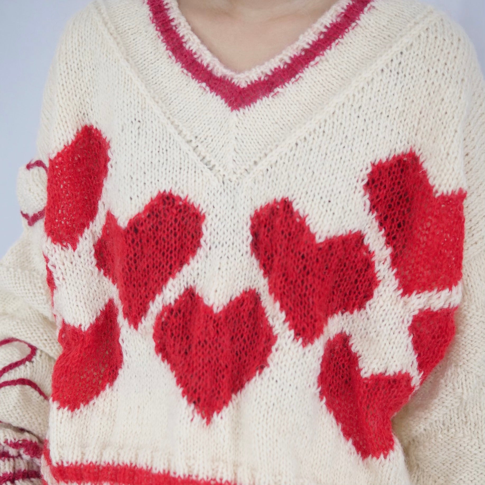 Hand-knitted sweater with lots hearts