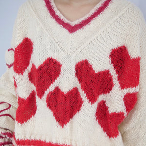 Hand-knitted sweater with lots hearts
