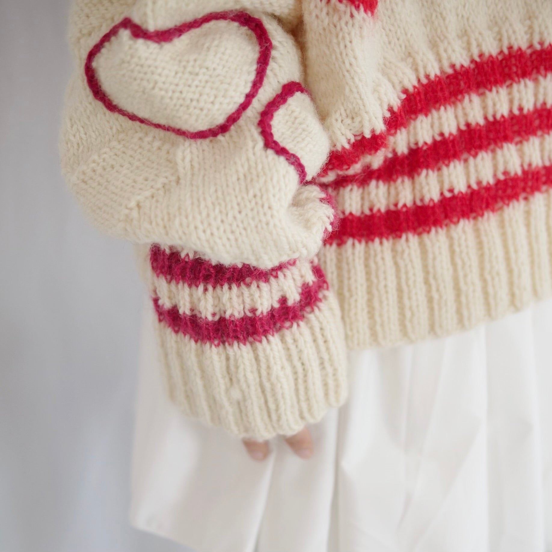 Hand-knitted sweater with lots hearts