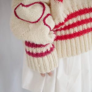 Hand-knitted sweater with lots hearts