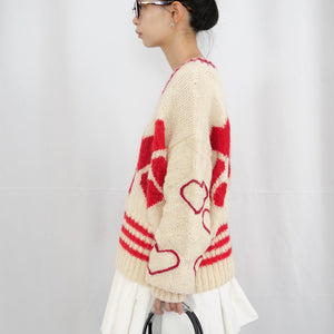 Hand-knitted sweater with lots hearts