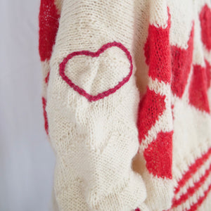 Hand-knitted sweater with lots hearts