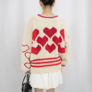 Hand-knitted sweater with lots hearts