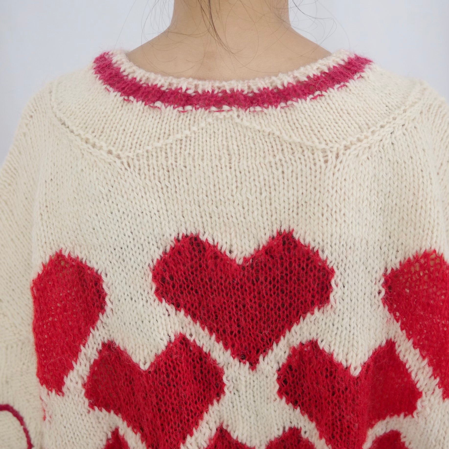 Hand-knitted sweater with lots hearts