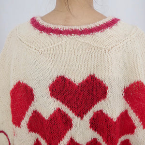 Hand-knitted sweater with lots hearts
