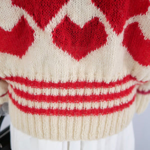 Hand-knitted sweater with lots hearts
